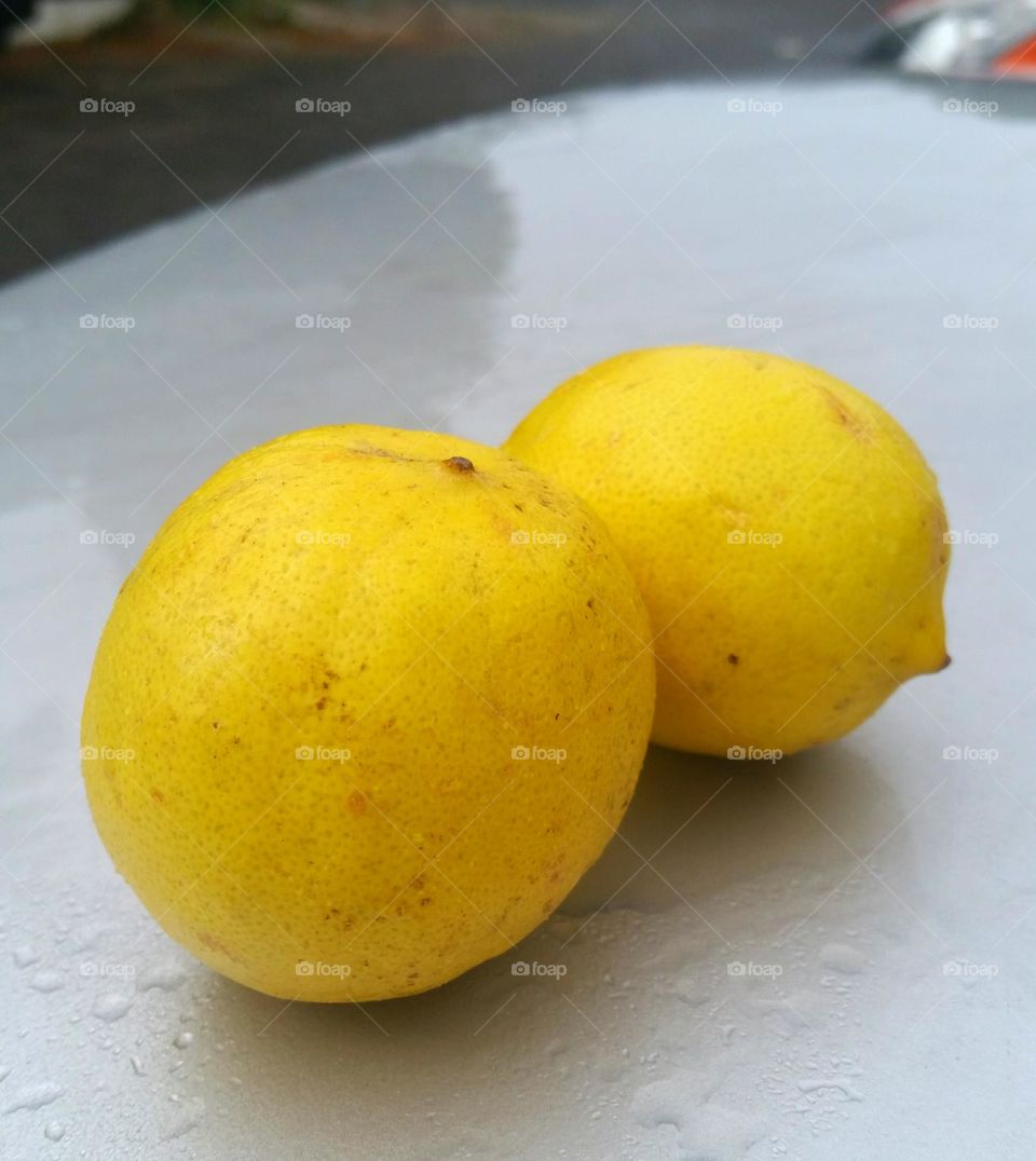 Two lemons at the top of car trunk...