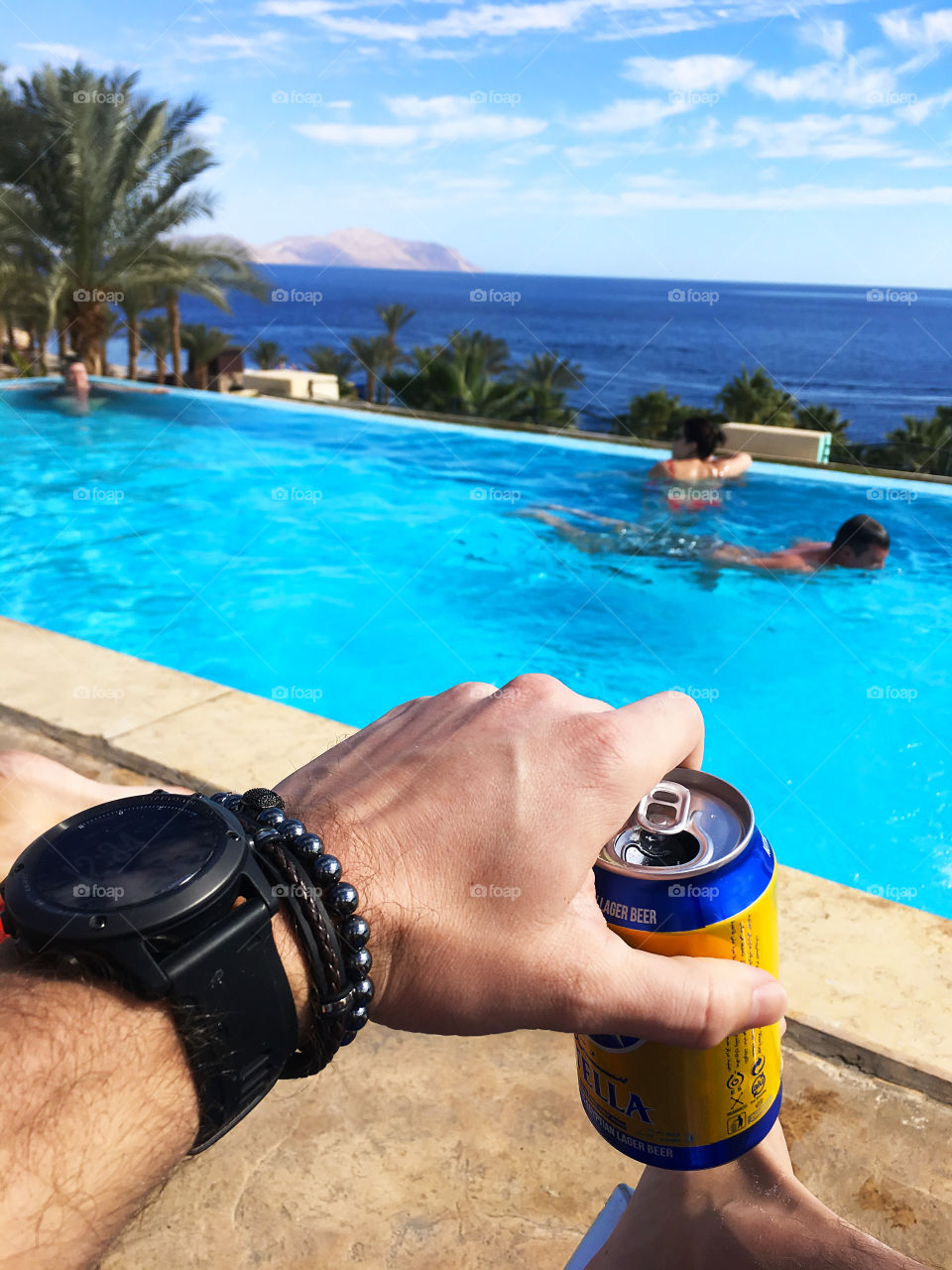 Enjoying the last summer days with beer at the swimming pool 