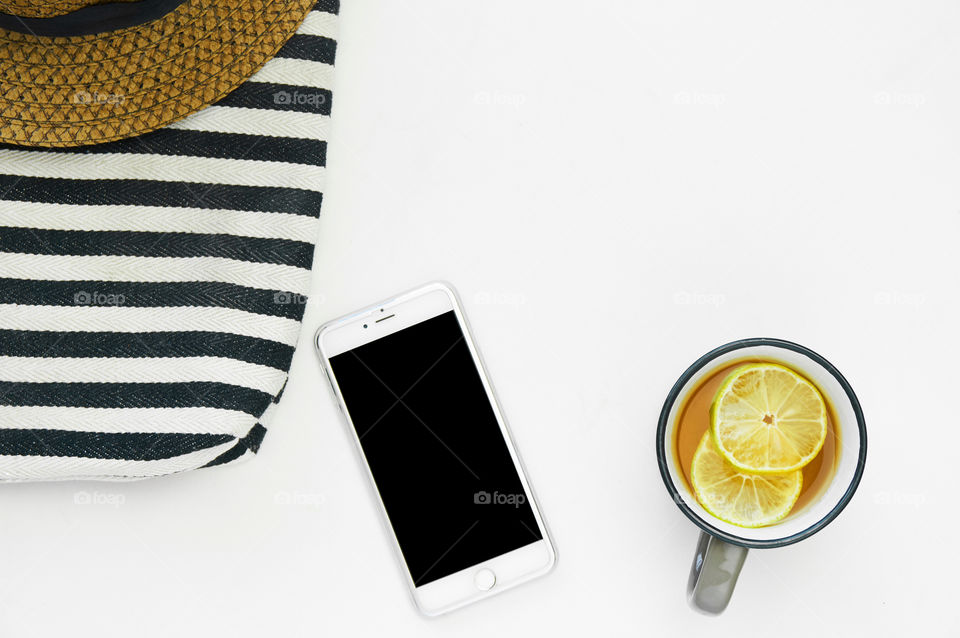 Smartphone and tea cup on gray background 
