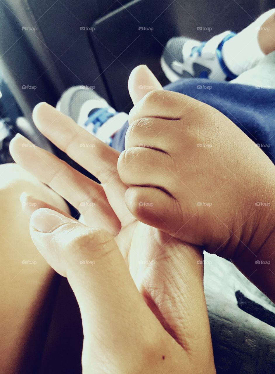 Toddler holding hand