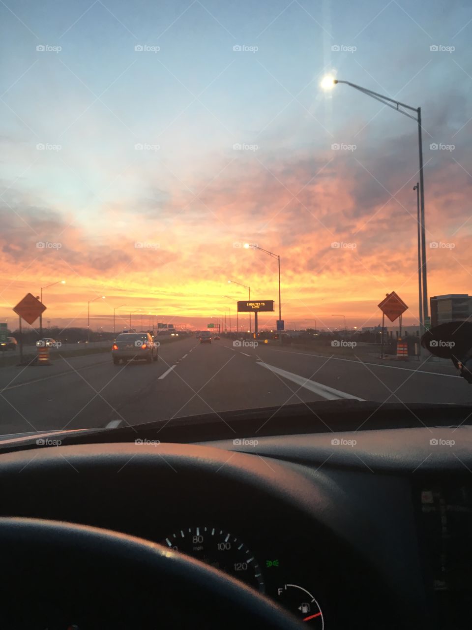 Driving towards the orange sunset