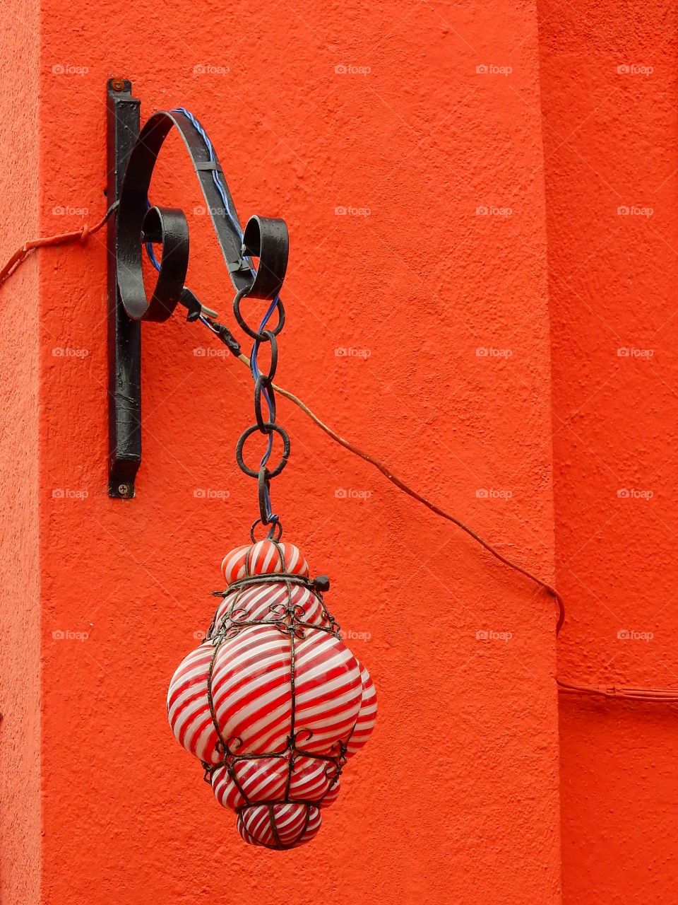 Handmade glass lamp on orange wall