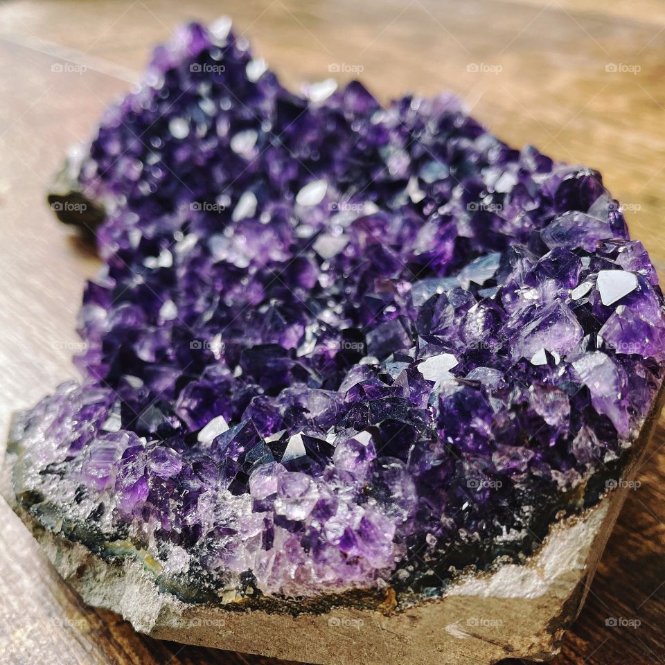 Chunk of a deep purple amethyst geode. Detailed foreground fading to a blurred background