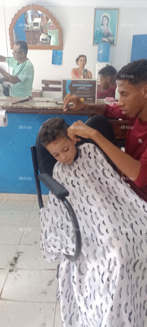 Boy falls asleep while cutting his hair