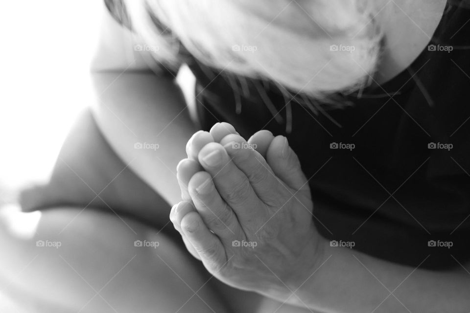 Black and white woman praying in reverent position 
