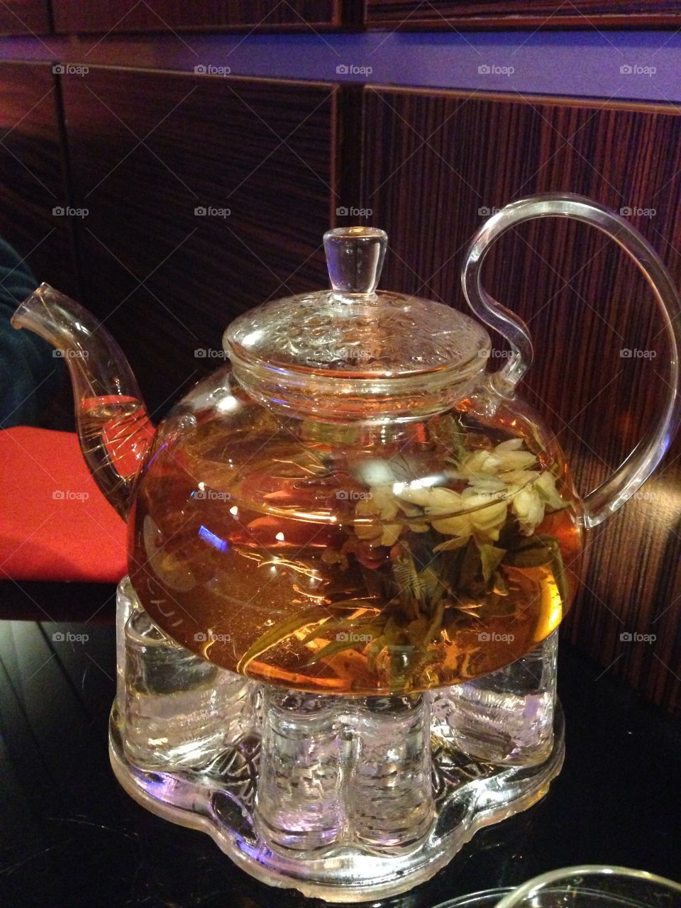 Jasmine tea brewing made with a real flower in a glass teapot in a Chinese restaurant