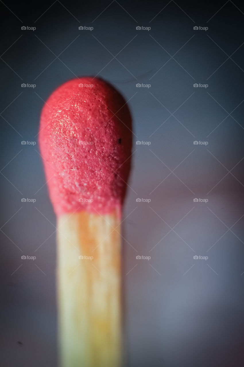 Macro image of a matchstick tip and pink sulfur wood head that beautifully displays the details ready to fire