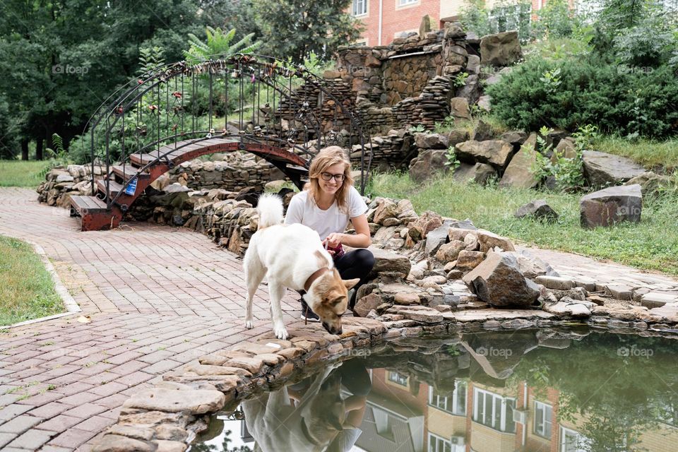 woman walking the dog in rainy day