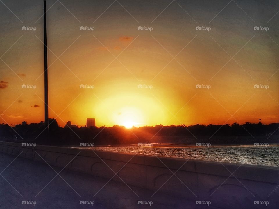 Beautiful sunset colored rays reflecting over the lake 