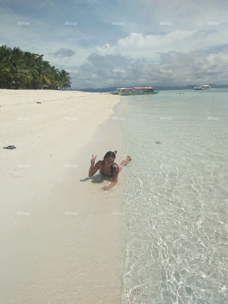 sun bathing with the clear water and the white sand in kalanggaman island