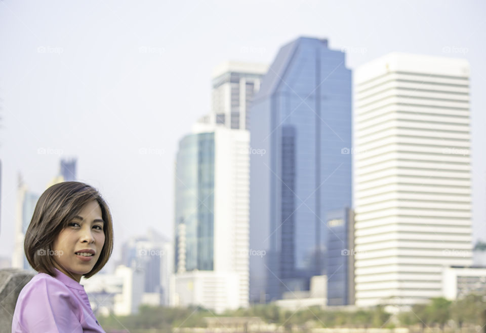 Portrait of Asean Women with short hair brown Background Building blurry.