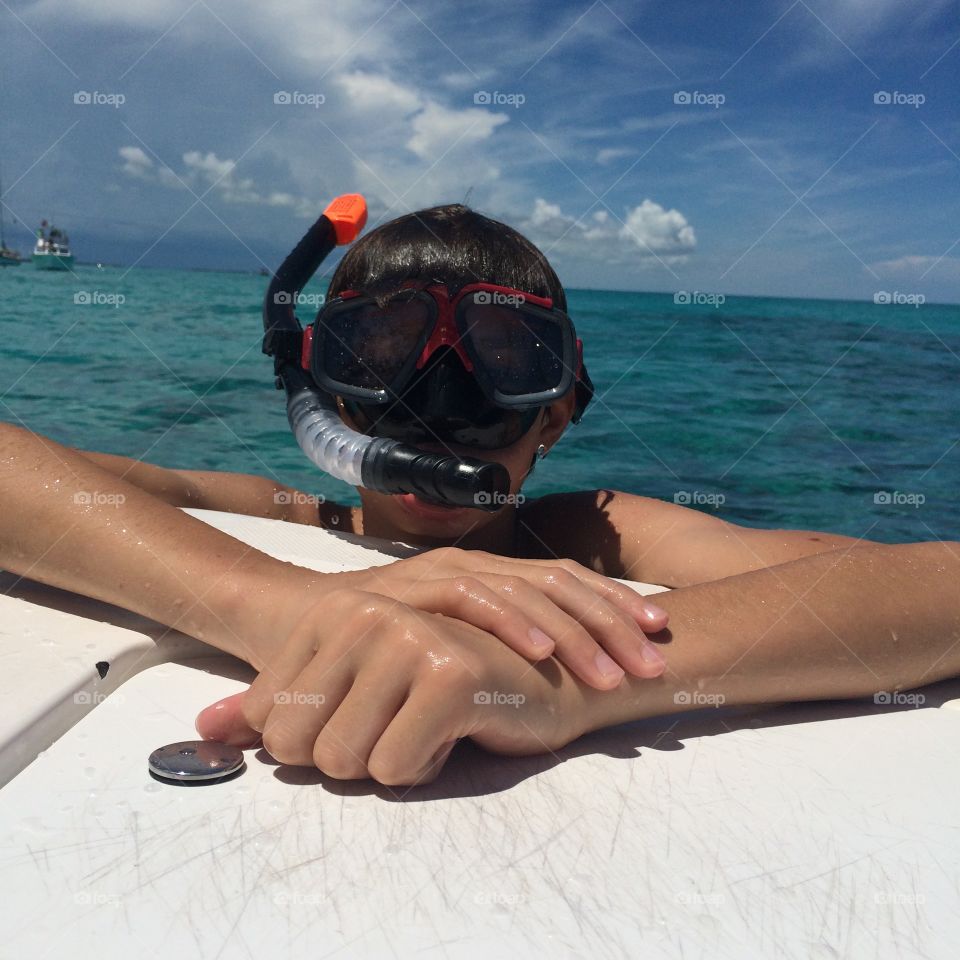 Snorkel Boy. Boy taking a break on the boat while snorkeling off the Florida Keys. 