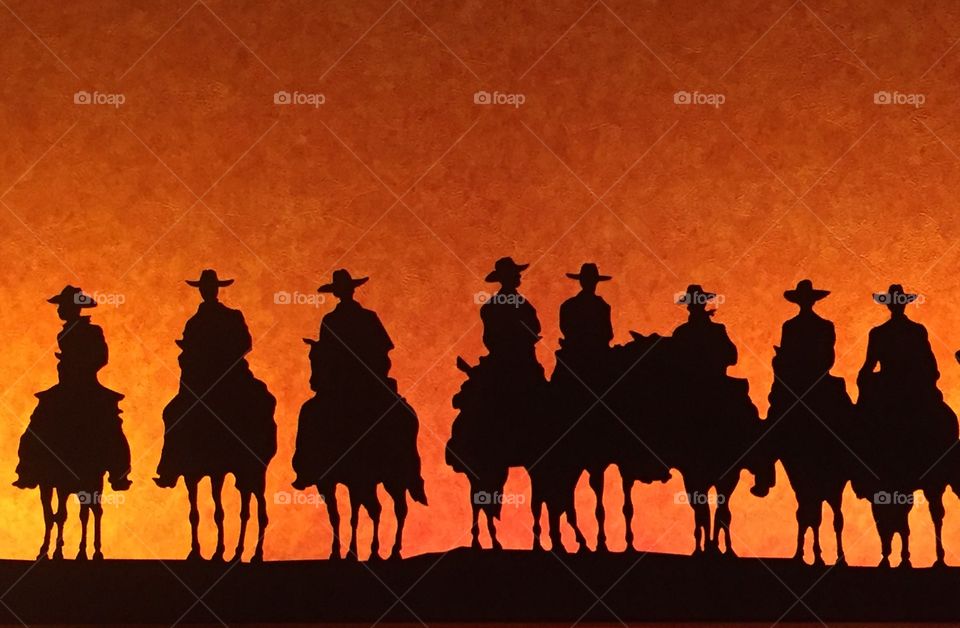Cowboys riding off into the sunset 