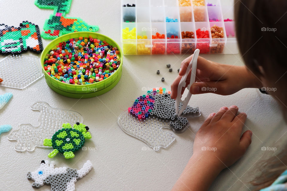 Child creating Fuse Beads picture