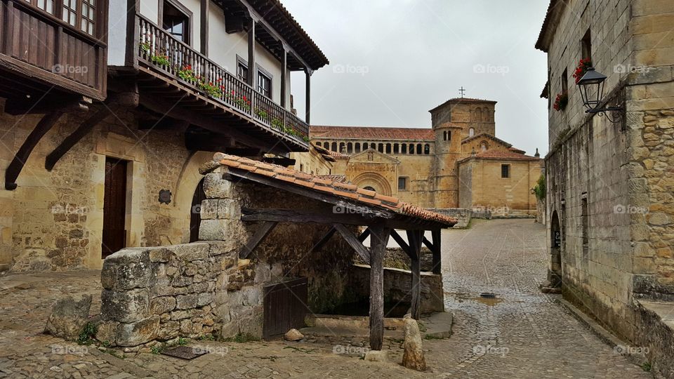 Santillana del Mar. Washing place and collegiate church in the background.