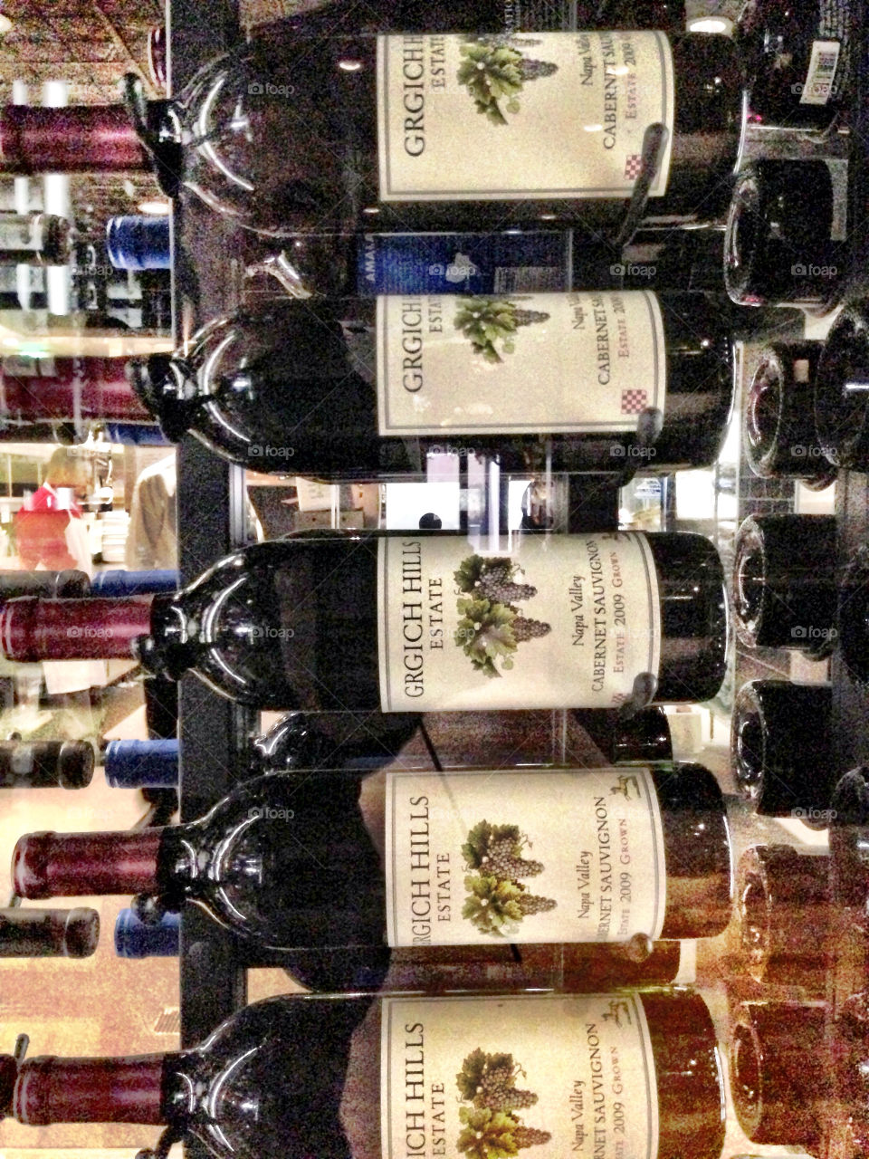 Bottles of red wine on a rack in restaurant