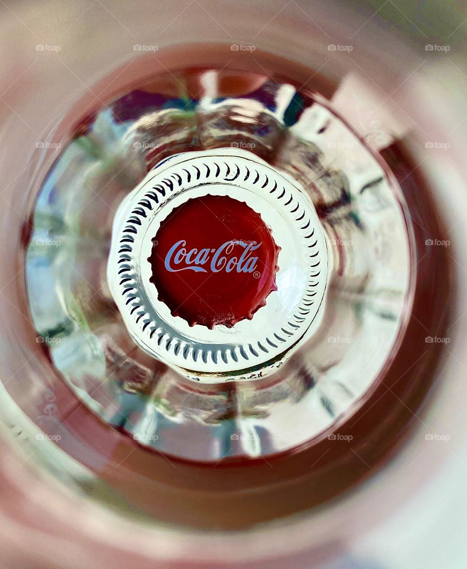 coca-cola's cap at the bottom of bottle