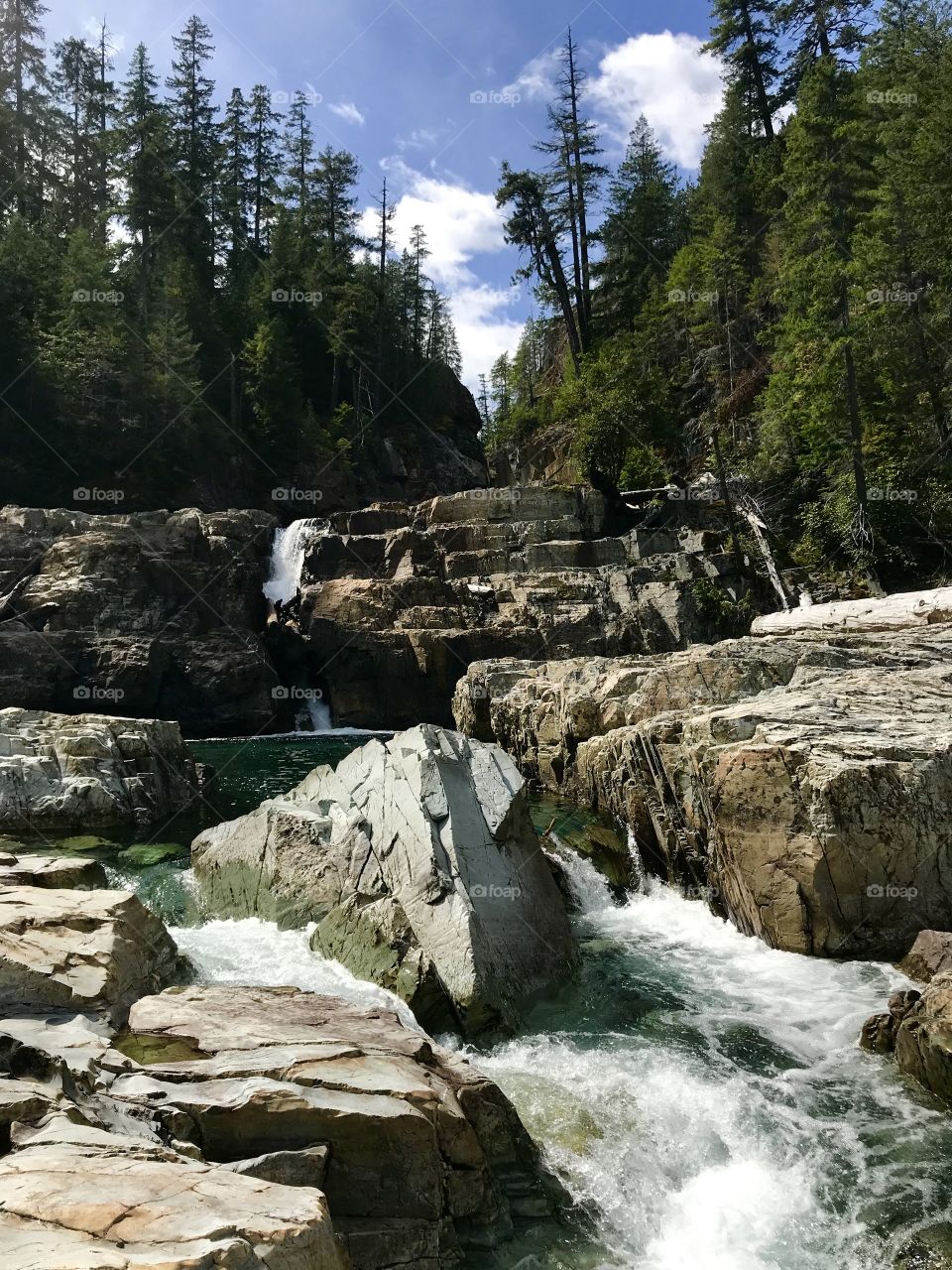 Trailing waterfall through rocks.