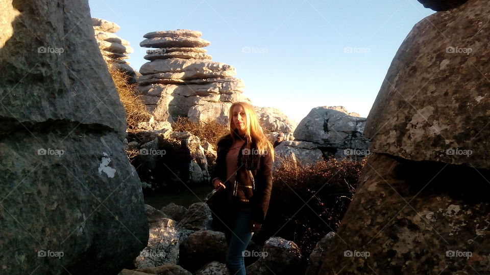 Woman standing near rock formation