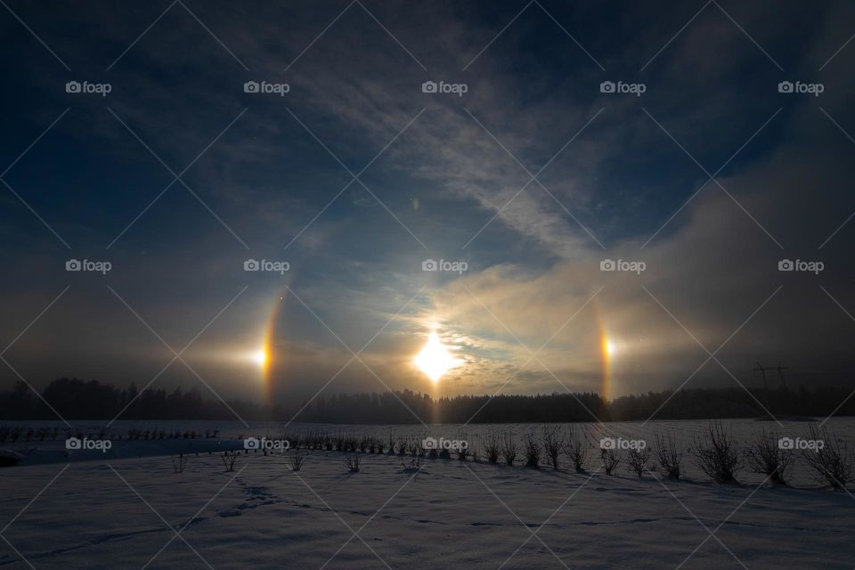 Sunset in the winter and natural atmospheric phenomenon Halo, parhelion  parhelia,sundog in Latvia