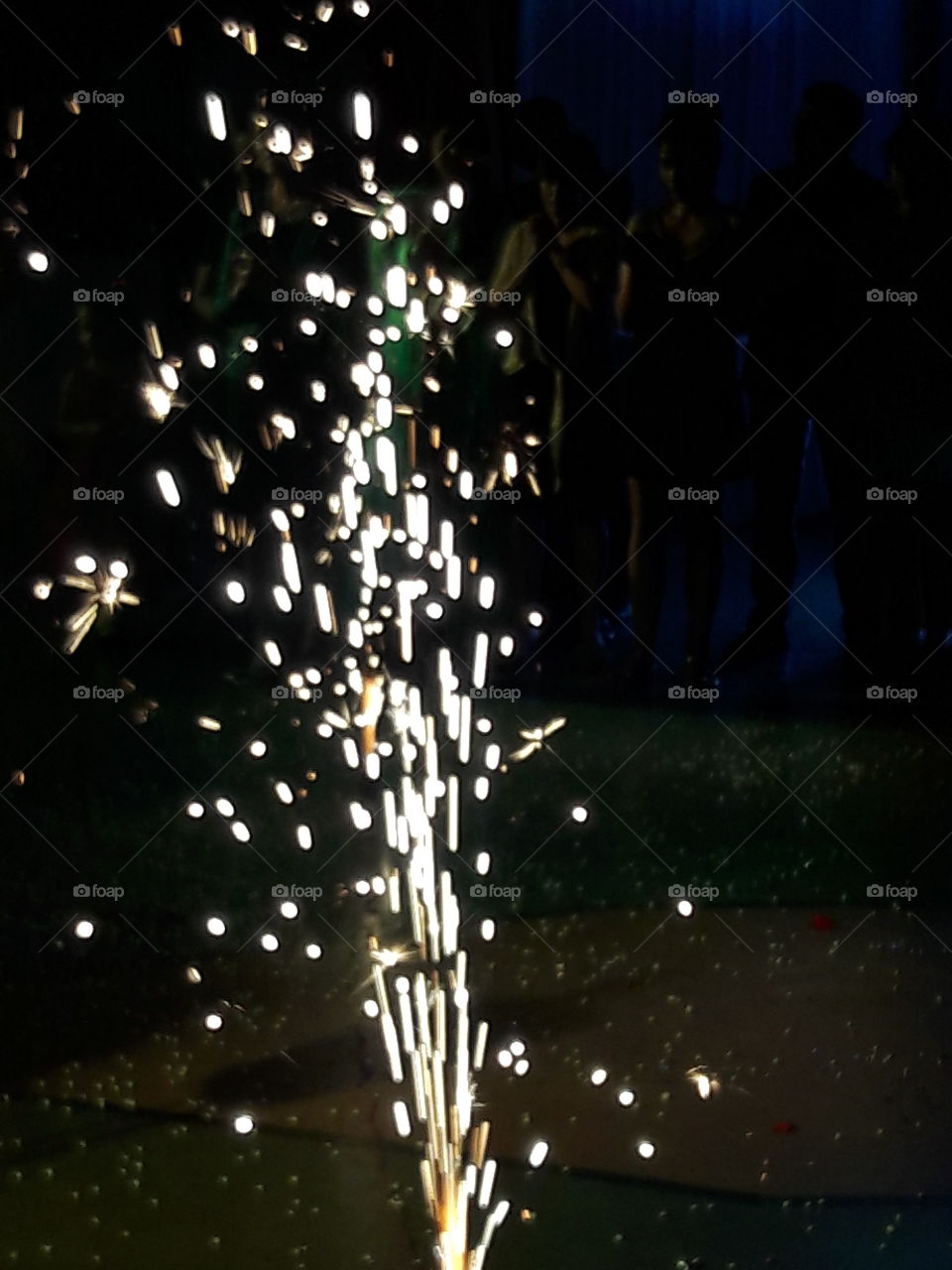 ground sparkling fireworks with spectators enjoying the light crackers sparklesat party