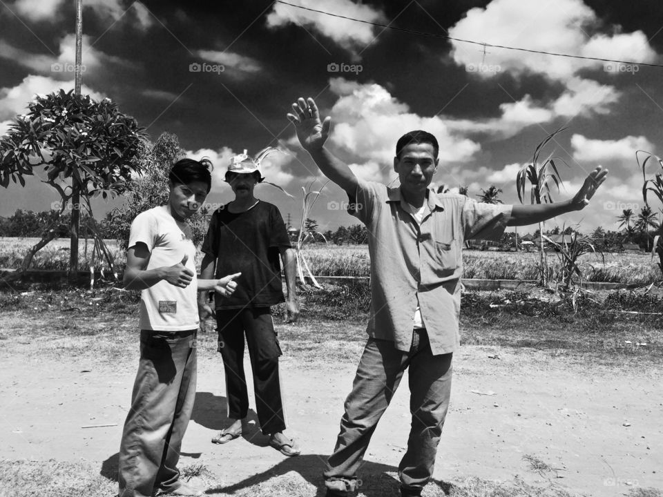 Asian man standing near field