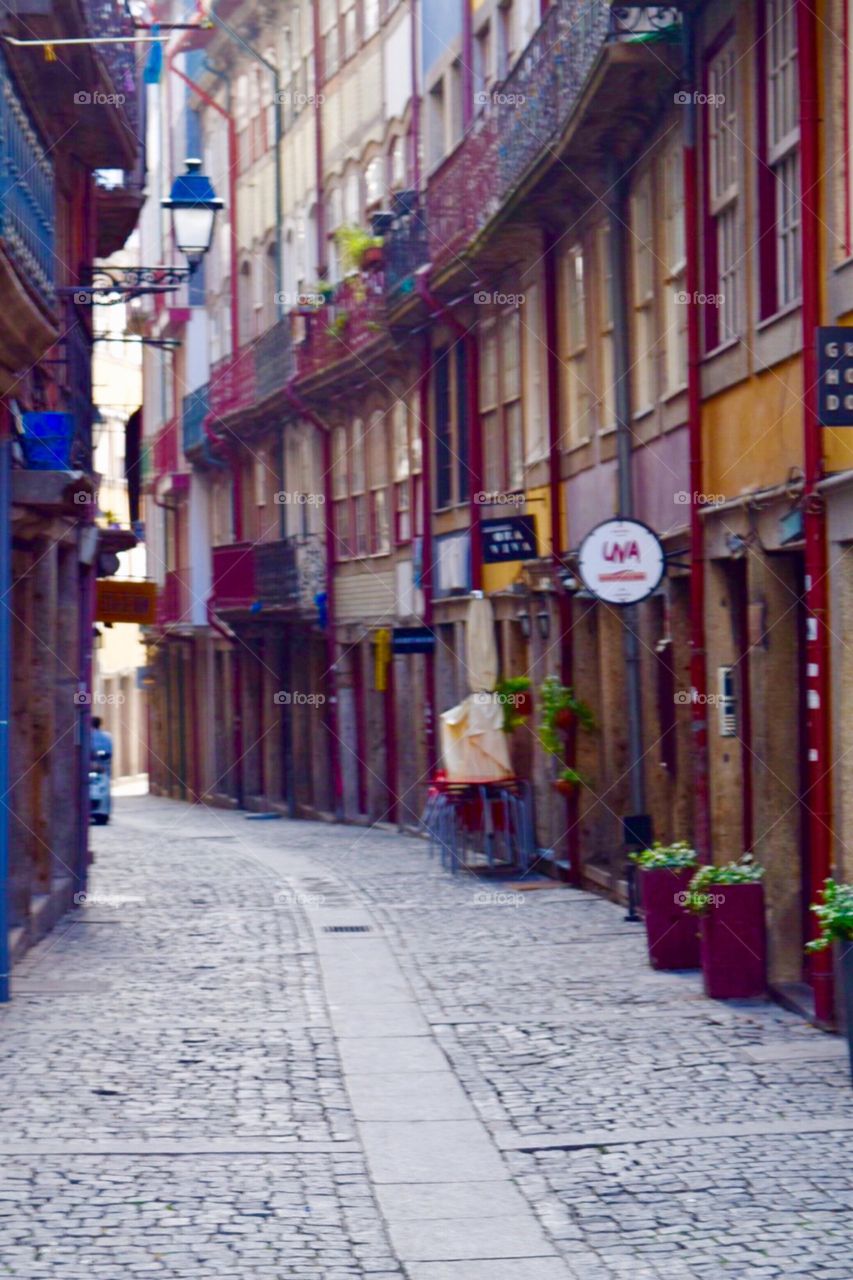 Colourful houses and restaurants in a narrow street of porto 