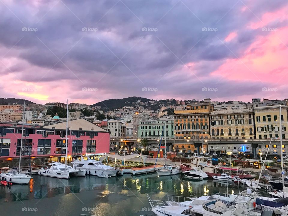Boats and buildings in Genova, Italy at twilight hour