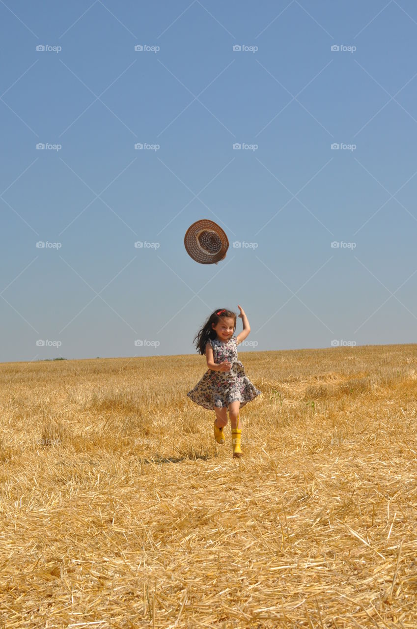 Girl throwing hat in air