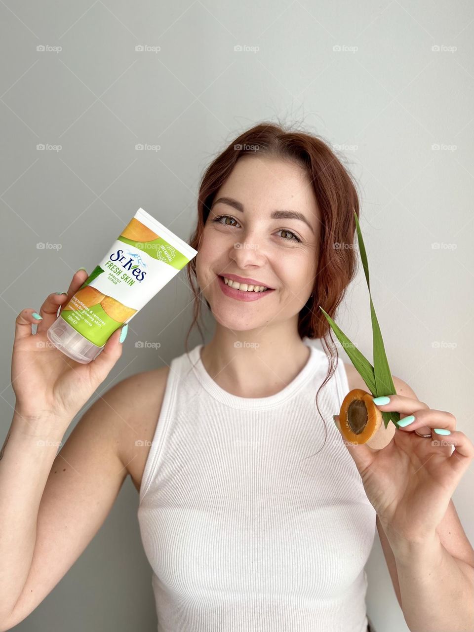 St. Ives fresh skin apricot scrub. Natural cosmetic for everyone. Photo without retouching. Natural beauty. Beautiful smile, beautiful young woman. 