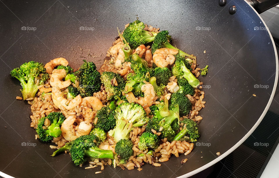 Cooking stir fry in a wok.