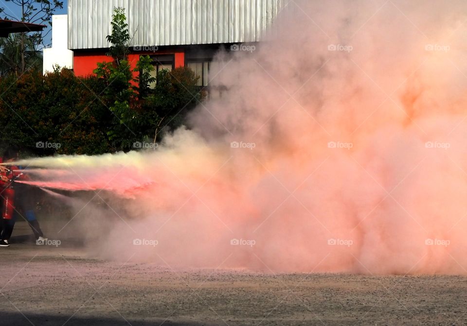 Firefighting drill using actual extinguishers and controlled fire.