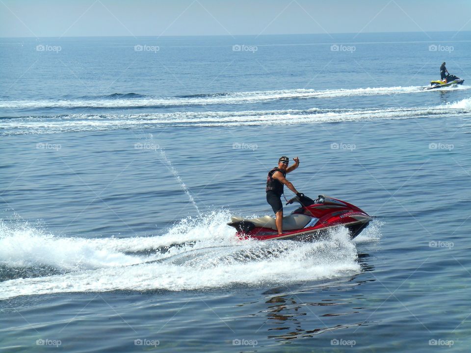 people riding on a water bike on a sea summer time