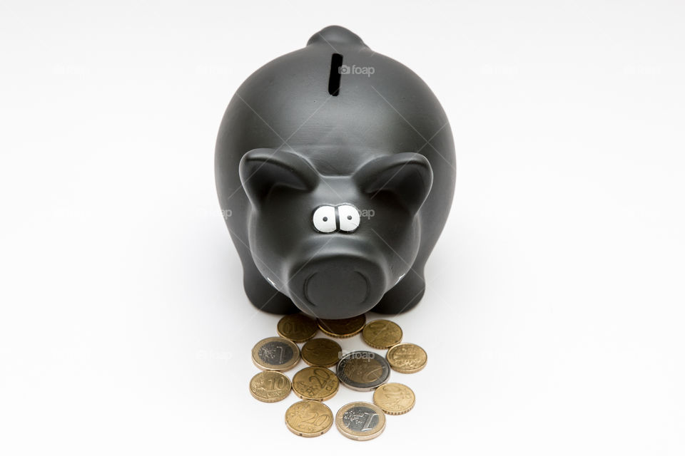 Black Piggy Bank With Coins, Isolated In White Backgound
