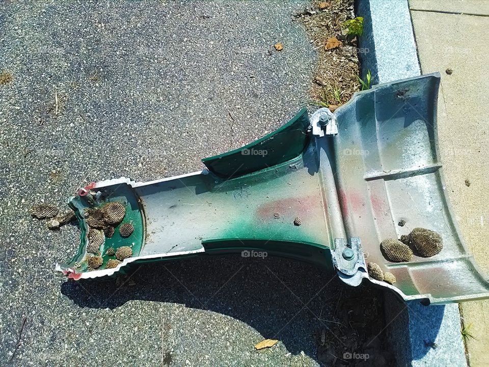 A cross-section of a lamp post filled with beehives