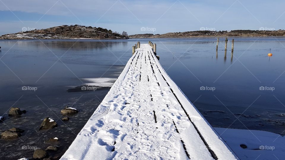 Beautiful sunny winter day on a pier with snow by the ocean, Sweden - vacker solig dag på brygga med snö vid havet en fin vinterdag , västkusten Sverige