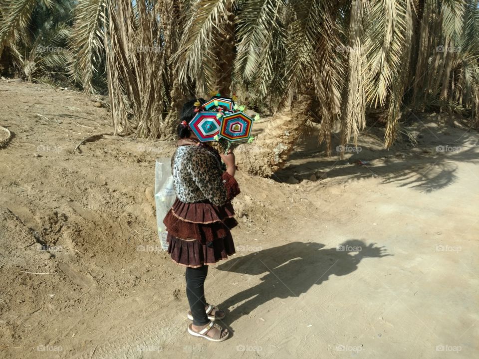 A shy girl from Siwa sells handicrafts - Egypt