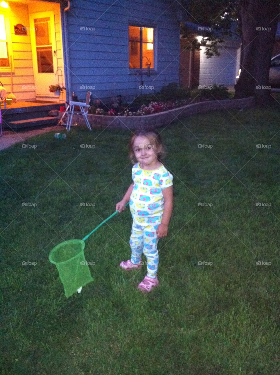 Catching Fireflies. Toddler, catching fireflies at dusk