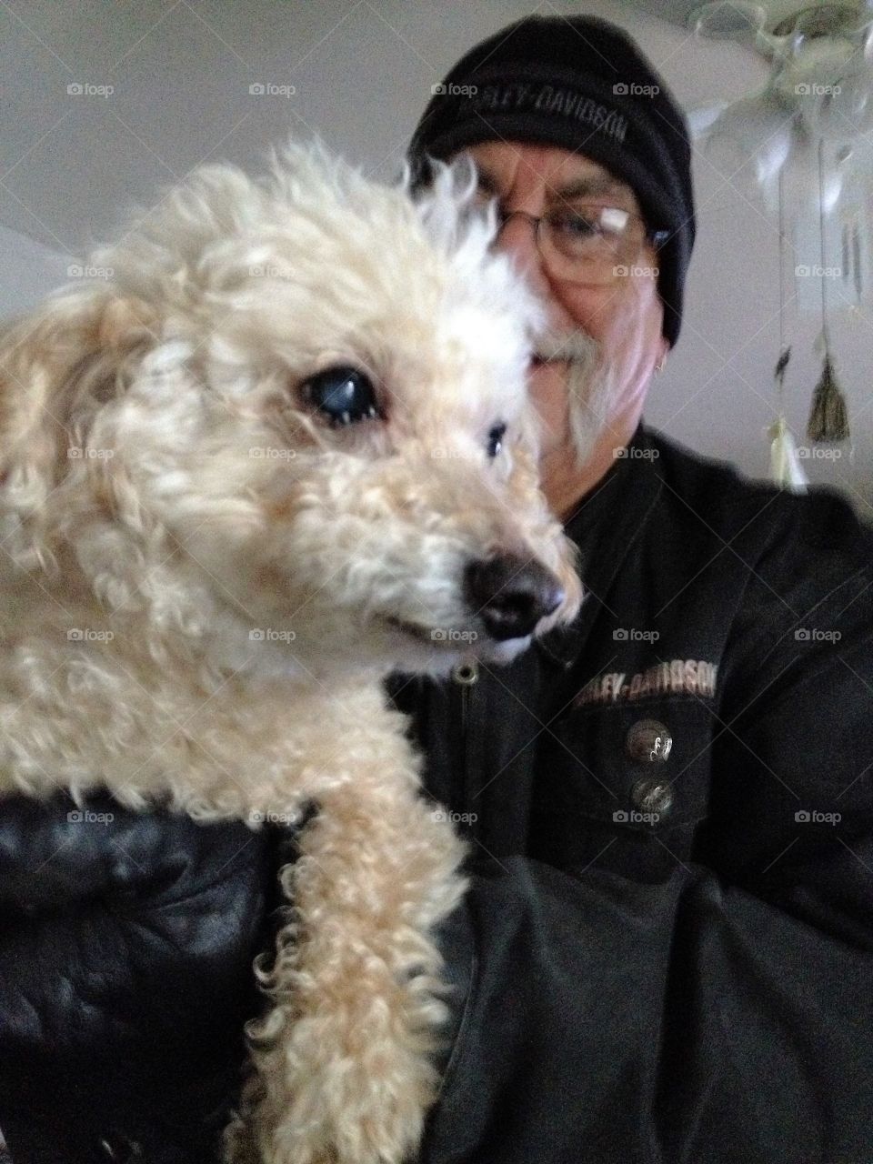 Man & his little white poodle dog.