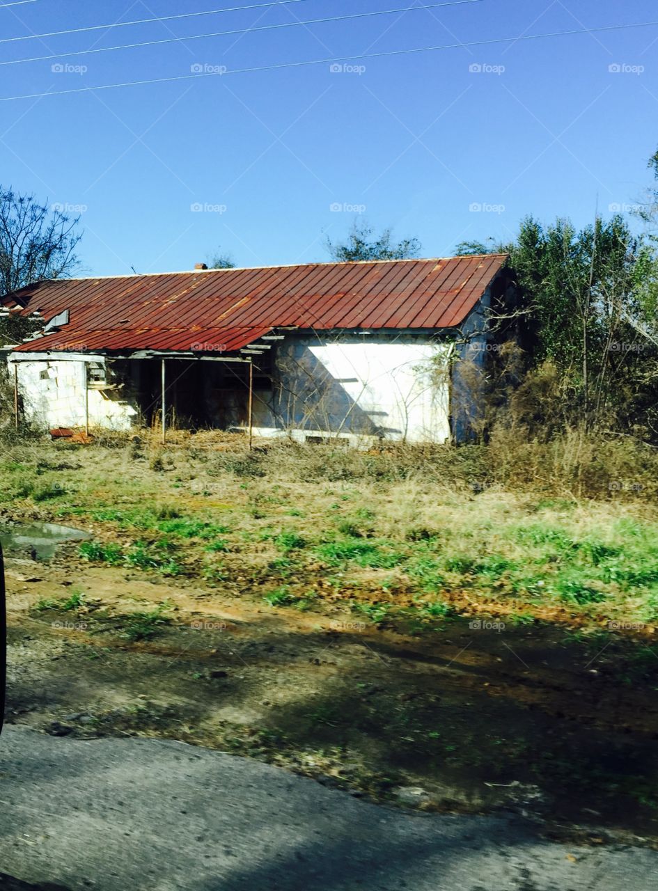 Old tin roofed structure grassy area