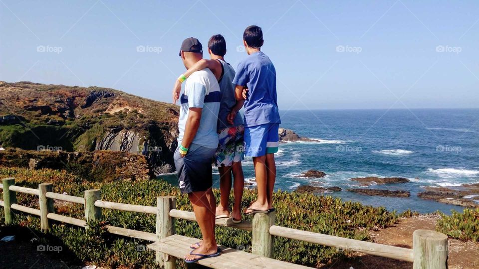 Father and sons admiring a gorgeous landscape view