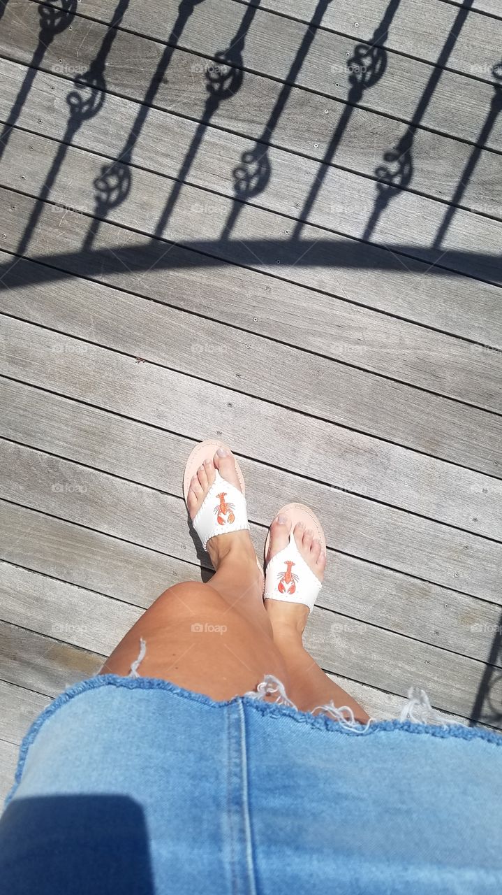White Lobster sandals on deck