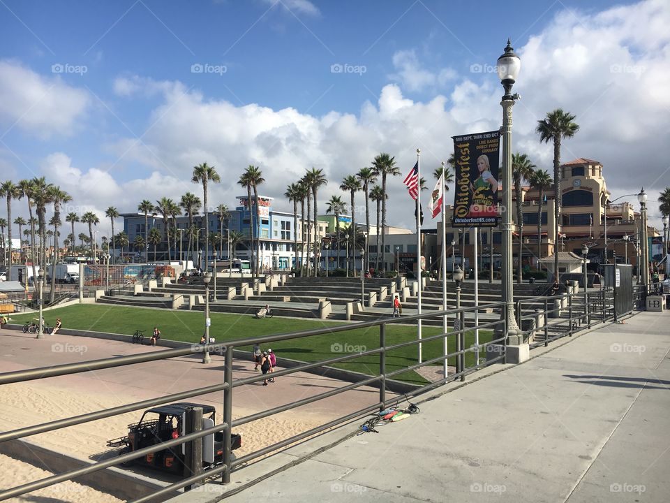 A look back from the Huntington Beach pier. Under-appreciated view from the ocean back to the quaint city, bustling with people old and young, soaking up the sun and enjoying decades-old establishments aside new, modern spots