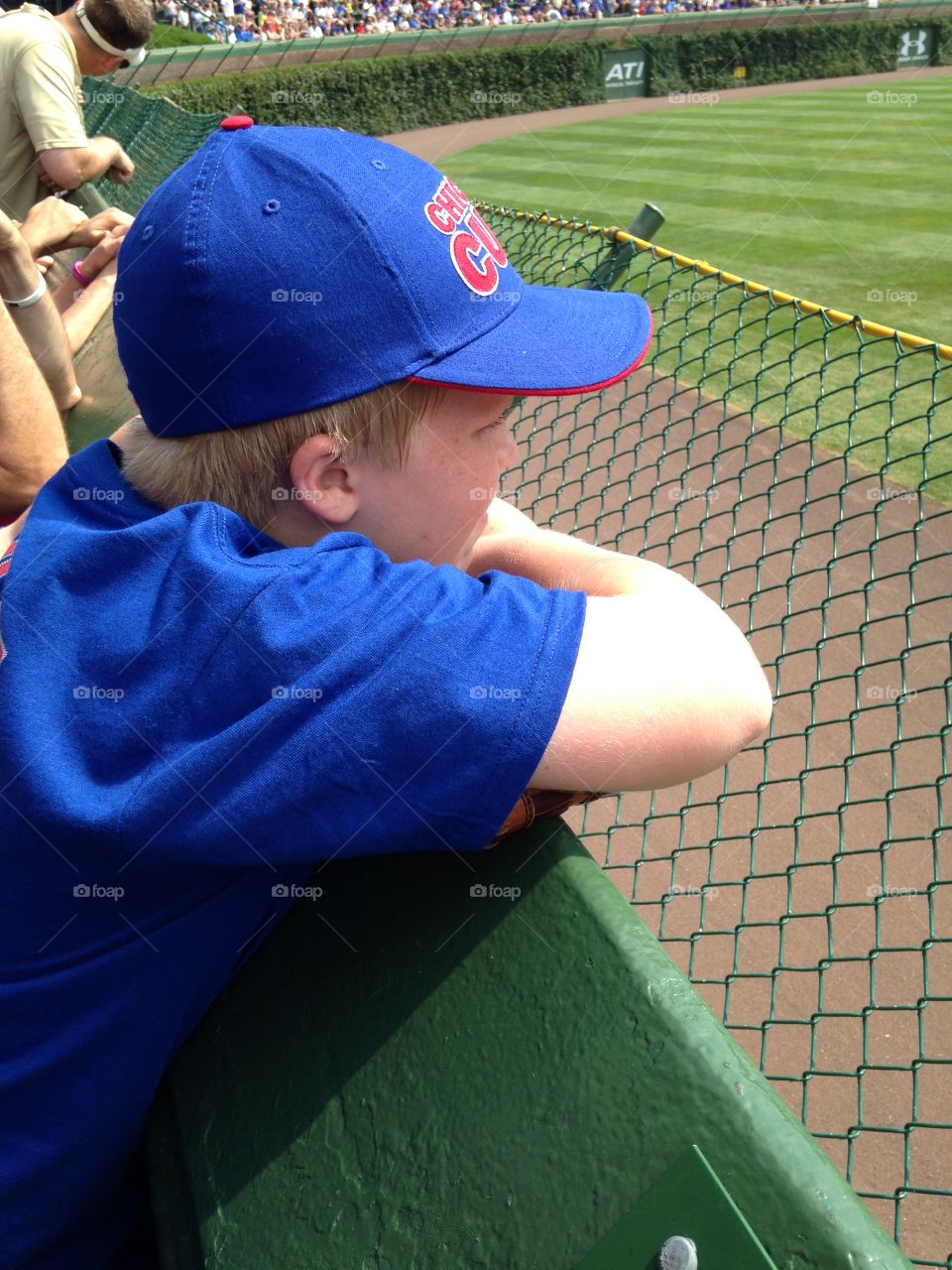 We love baseball . Grandson's first time at Wrigley Field front row in the bleachers waiting for the Cubs to take the field