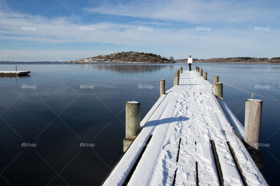 Enjoying a beautiful cold snowy day in the archipelago by the frozen ocean 
