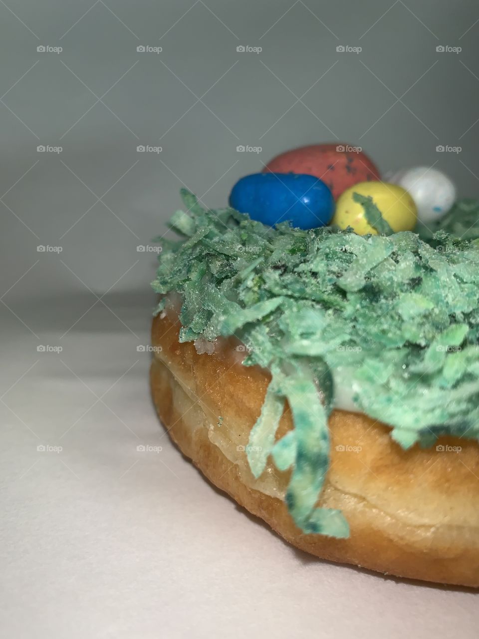 Big, delicious and captivating to the eye. A picture taken of an Easter themed donut with just enough coconut!