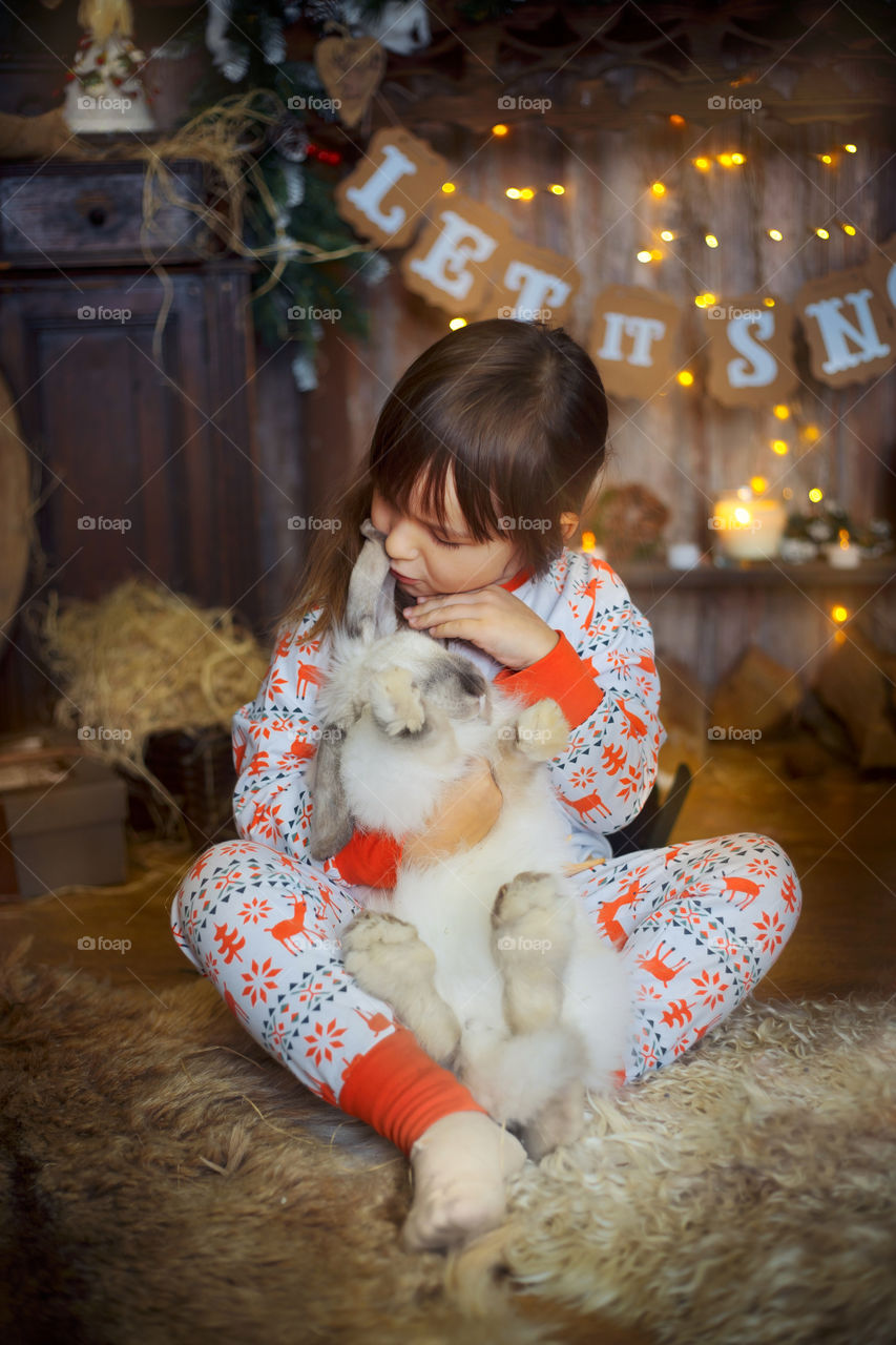 Little sisters near fireplace at Christmas Eve 