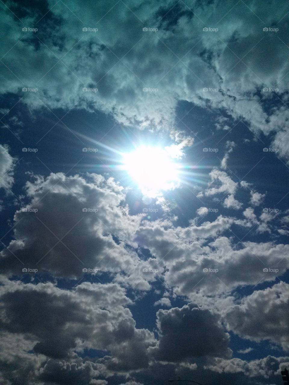 Beautiful, Amazing, Clouds
With the Sun Beaming 
Through with colorful rays
Blue, Purple, Pink and White
My Oh My, What an Amazing 
Site.  Glory Be How Fortunate 
I am to be able to catch such 
A Wonderful site!!