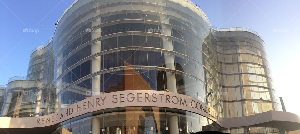 A reflection of the Firebird sculpture at Orange County Performing Arts Center can be seen in the glass of the Renee and Henry Segerstrom Concert Hall in Costa Mesa, California, home of the Pacific Symphony.