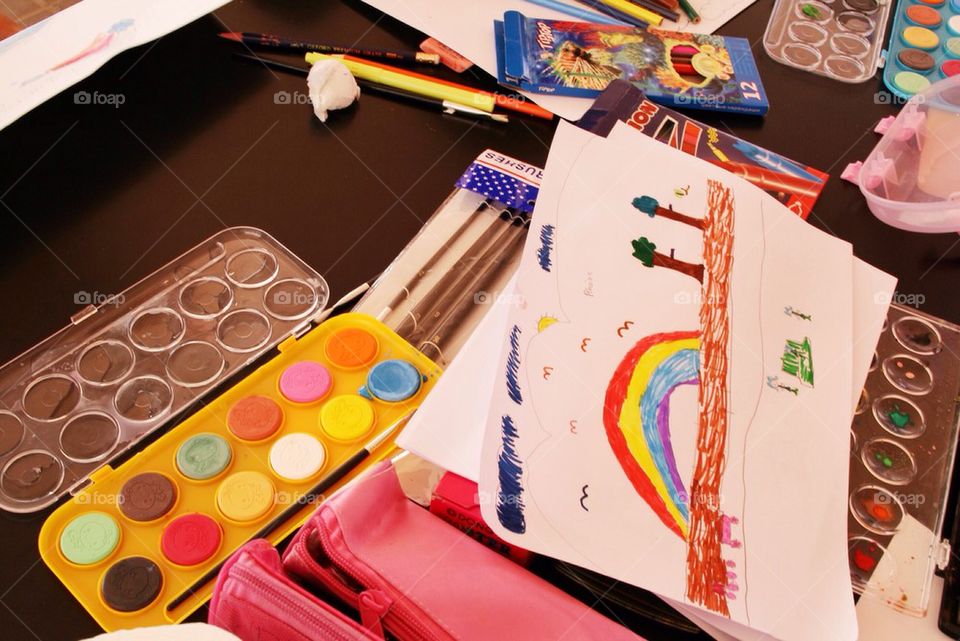 A kid's art work in a messy desk